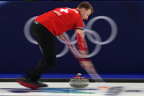 Switzerland's Yannick Schwaller in action during the mixed doubles round robin phase of the curling competition against Sweden at the 2026 Winter Olympics, in Cortina d'Ampezzo, Italy.
