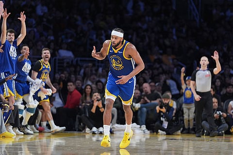 Golden State Warriors guard Moses Moody (4) celebrates his three-point basket during the second half of an NBA basketball game against the Los Angeles Lakers in Los Angeles.