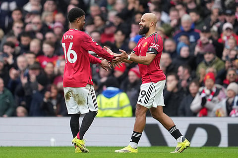 Manchester United's Amad Diallo, left, and Bryan Mbeumo react after a goal during the English Premier League soccer match between Manchester United and Tottenham in Manchester, England.