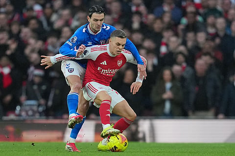 Sunderland's Enzo Le Fee holds Arsenal's Leandro Trossard during the English Premier League soccer match between Arsenal and Sunderland in London, England.