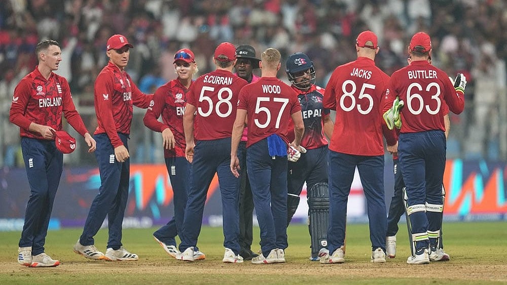 Photo: AP/Rafiq Maqbool : England players celebrate after wining against Nepal during the T20 World Cup cricket match in Mumbai, India.