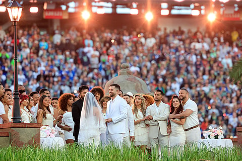 A couple gets married in a real ceremony during the halftime show of Super Bowl 60 between the Seattle Seahawks and New England Patriots in Santa Clara, California.