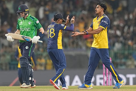 Sri Lanka's Maheesh Theekshana, right, celebrates the wicket of Ireland's Gareth Delany during the T20 World Cup cricket match between Sri Lanka and Ireland in Colombo, Sri Lanka.