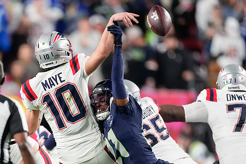 New England Patriots quarterback Drake Maye (10) fumbles as he is sacked by Seattle Seahawks cornerback Devon Witherspoon (21) during the second half of the NFL Super Bowl 60 football game in Santa Clara, California.
