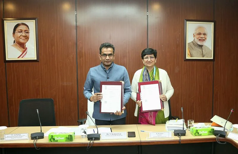 Two officials hold signed documents
