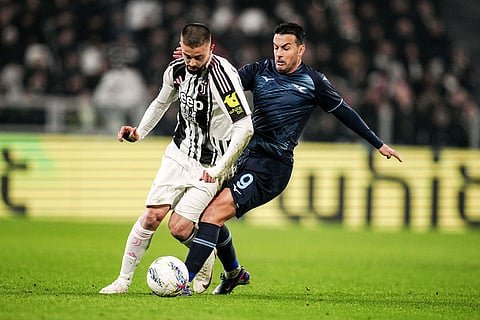 Juventus' Edon Zhegrova, left, fights for the ball with Lazio's Pedro during the Serie A soccer match between Juventus and Lazio, in Turin, Italy.