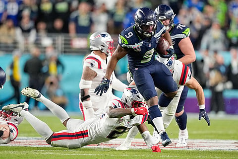 Seattle Seahawks running back Kenneth Walker III (9) leaps for yardage during the second half of the NFL Super Bowl 60 football game against the New England Patriots in Santa Clara, California.