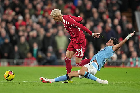 Manchester City's Matheus Nunes tackles Liverpool's Hugo Ekitike during the English Premier League soccer match between Liverpool and Manchester City in Liverpool, England.