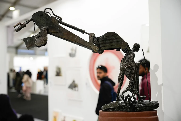 Debanjan Roy’s sculpture at India Art Fair places a modest Gandhi under the looming arm of a bulldozer - Vikram Sharma
