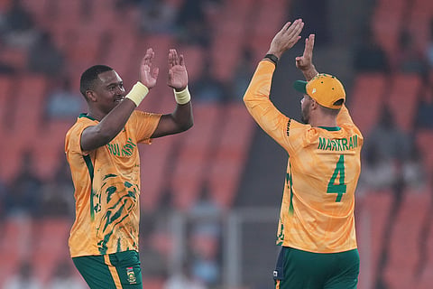 South Africa's Lungi Ngidi, left, and South Africa's captain Aiden Markram celebrates the wicket of Canada's Harsh Thaker during the T20 World Cup cricket match between Canada and South Africa in Ahmedabad.