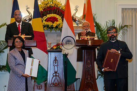 High Commissioner of India to Seychelles Rohit Rathish, right, and High Commissioner of Seychelles to India Lalatiana Accouche exchange documents during a joint press statement after a meeting between Prime Minister Narendra Modi and President of Seychelles Patrick Herminie, at the Hyderabad House, in New Delhi.