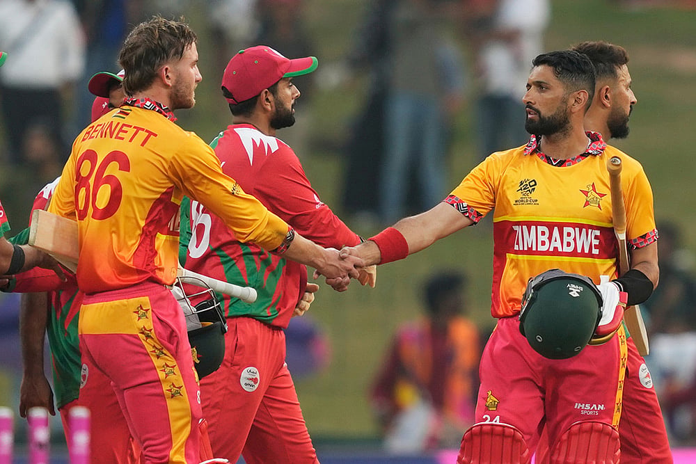 | Photo: AP/Eranga Jayawardena : Zimbabwe's captain Sikandar Raza, right, Brian Bennett, left, celebrate after winning their T20 World Cup cricket match against Oman in Colombo, Sri Lanka.