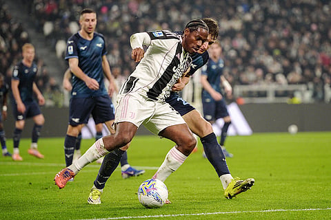 Juventus' Jonathan David, front, and Lazio's Toma Basic in action during the Serie A soccer match between Juventus and Lazio in Turin, Italy.
