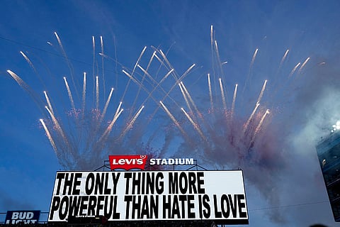 Fireworks fill the sky as a message is seen on a video board during halftime of the NFL Super Bowl 60 football game between the New England Patriots and the Seattle Seahawks in Santa Clara, California.