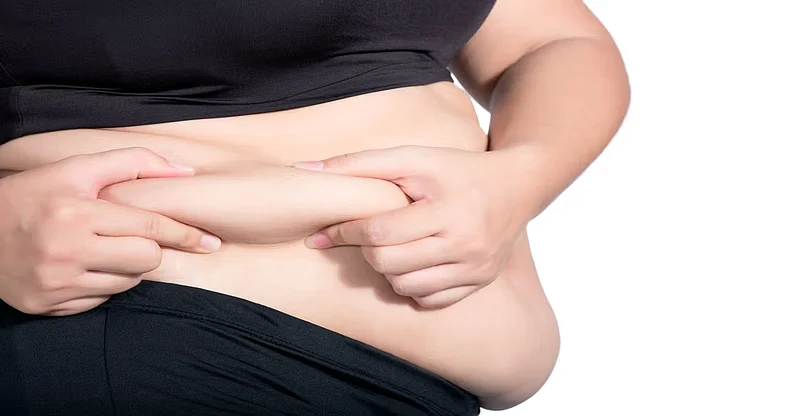 An Obese person pinching belly fat