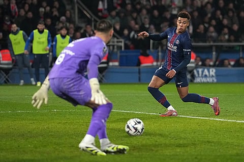 Marseille's goalkeeper Jeffrey de Lange, left, tries to block a shot from PSG's Desire Doue during the French League One soccer match between Paris Saint-Germain and Marseille in Paris.
