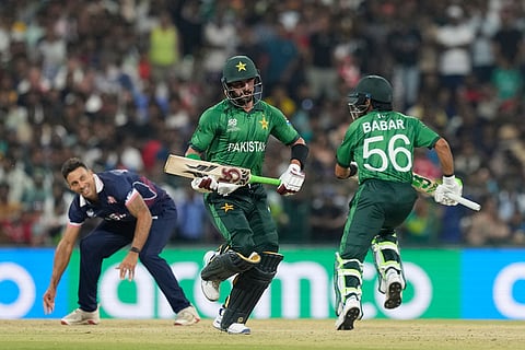 Pakistan's Babar Azam, right, along with Pakistan's Sahibzada Farhan run between the wickets to score during the T20 World Cup cricket match between Pakistan and the United States in Colombo, Sri Lanka.