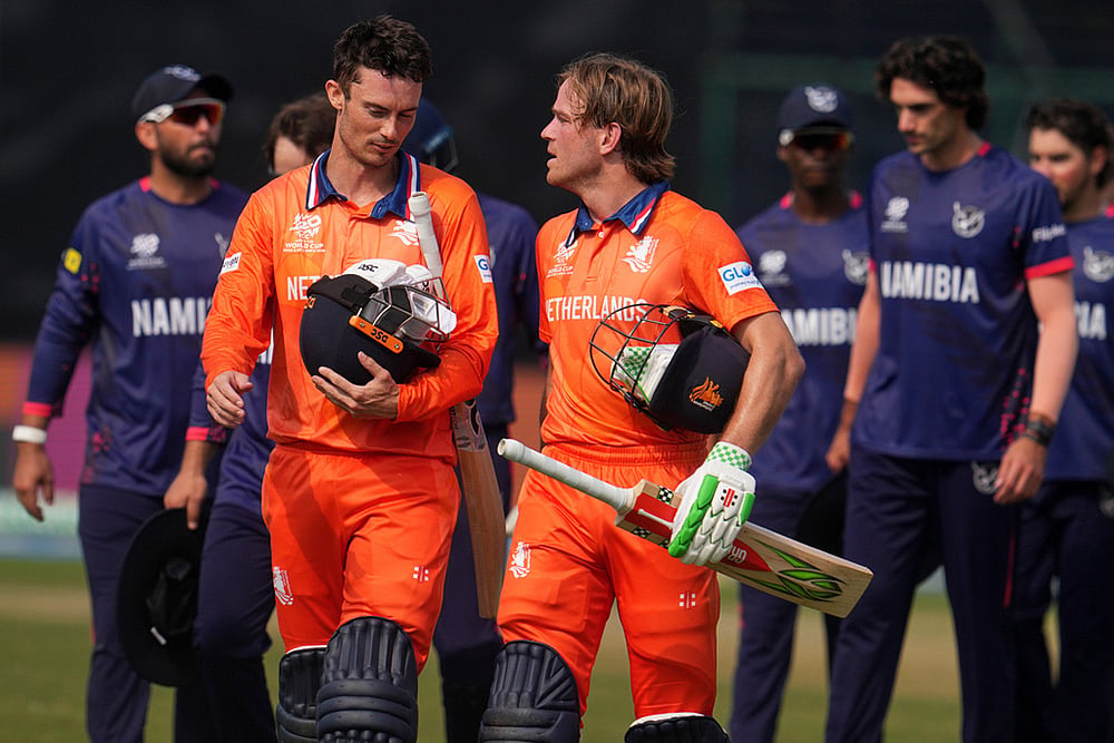 | Photo: AP/Manish Swarup : Netherlands' captain Scott Edwards, left and Netherlands' Bas de Leede walks out of the field after their win over Namibia during the T20 World Cup cricket match between Namibia and Netherlands in New Delhi.