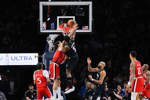 Minnesota Timberwolves guard Anthony Edwards, third from left, dunks against Los Angeles Clippers center Brook Lopez, second from left, during the second half of an NBA basketball game in Minneapolis.