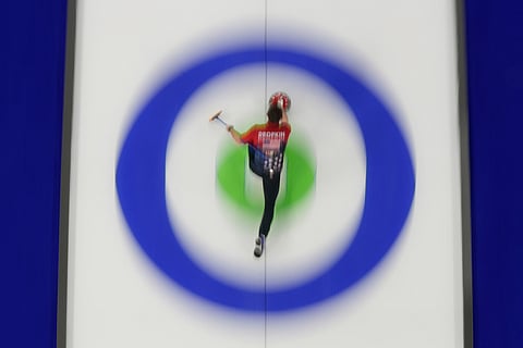 United States' Korey Dropkin delivers a stone against Italy during a curling mixed doubles session at the 2026 Winter Olympics, in Cortina d'Ampezzo, Italy.