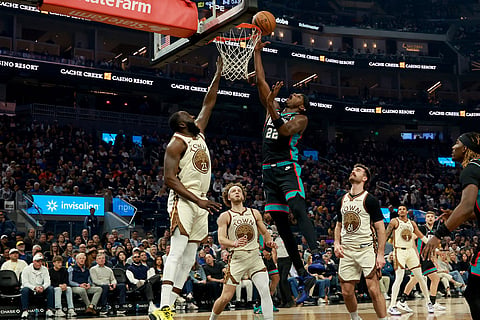 Memphis Grizzlies forward Taylor Hendricks (22) shoots against Golden State Warriors forward Draymond Green (23) during the first half of an NBA basketball game in San Francisco.