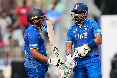 United Arab Emirates' Alishan Sharafu, left, celebrates as United Arab Emirates' captain Muhammad Waseem looks on his fifty runs during the T20 World Cup cricket match between New Zealand and United Arab Emirates in Chennai.