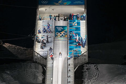 Domen Prevc, of Slovenia, goes down the ramp during his trial jump of the ski jumping men's normal hill individual at the 2026 Winter Olympics, in Predazzo, Italy.