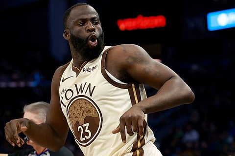 Golden State Warriors forward Draymond Green celebrates after scoring against the Memphis Grizzlies during the second half of an NBA basketball game in San Francisco.