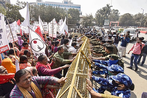 Security personnel stop members of AISA and AIPWA during a protest march towards the Vidhan Sabha over the alleged death of a NEET aspirant and against rising violence against women, in Patna.