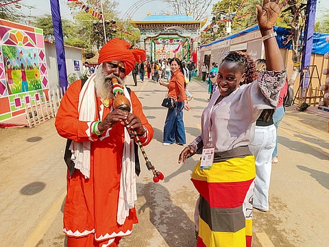 A snake charmer plays a flute during the 'Surajkund International Crafts Mela', in Faridabad.