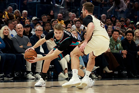 Memphis Grizzlies guard Cam Spencer, left, is defended by Golden State Warriors guard Pat Spencer, right, during the first half of an NBA basketball game in San Francisco.