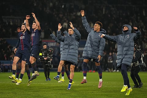 PSG players celebrate at the end of the French League One soccer match between Paris Saint-Germain and Marseille in Paris.