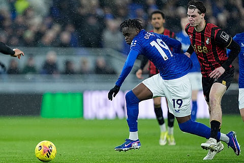 Bournemouth's Alex Scott, right, and Everton's Tyrique George battle for the ball during their English Premier League soccer match in Liverpool, England.