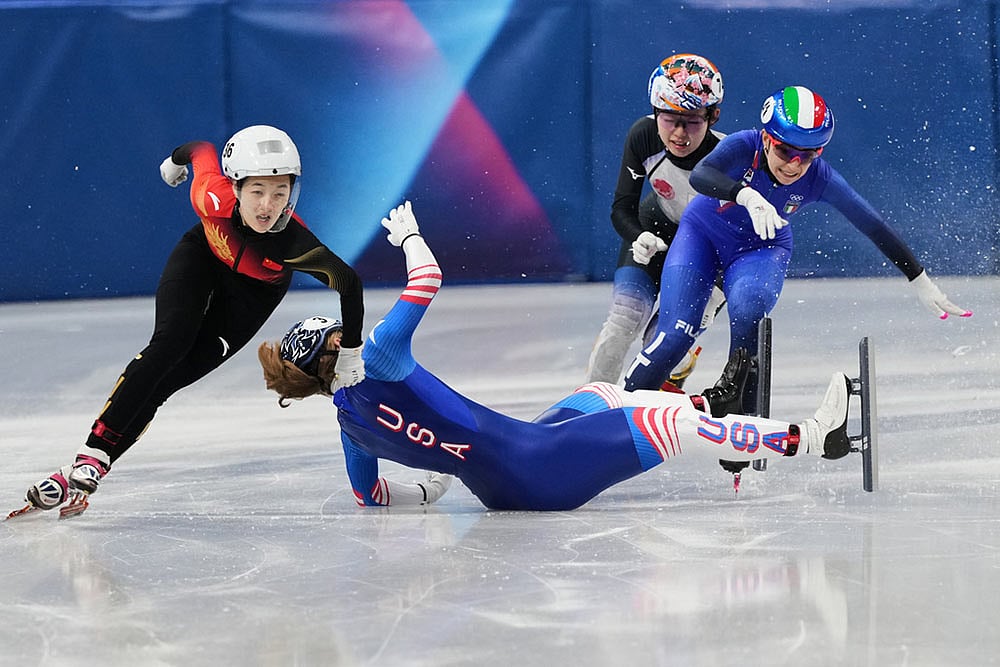 | Photo: AP/Francisco Seco : Corinne Stoddard of the United States wipes out as Xinran Wang of the People's Republic of China moves past to win while competing in the women's 500 meter short track speed skating at the 2026 Winter Olympics, in Milan, Italy.