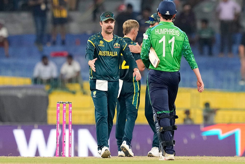Photo: AP/Eranga Jayawardena : Australia's captain Travis Head, left, walks to shake hands with Ireland's Matthew Humphreys after Australia won the T20 World Cup cricket match against Ireland in Colombo, Sri Lanka.
