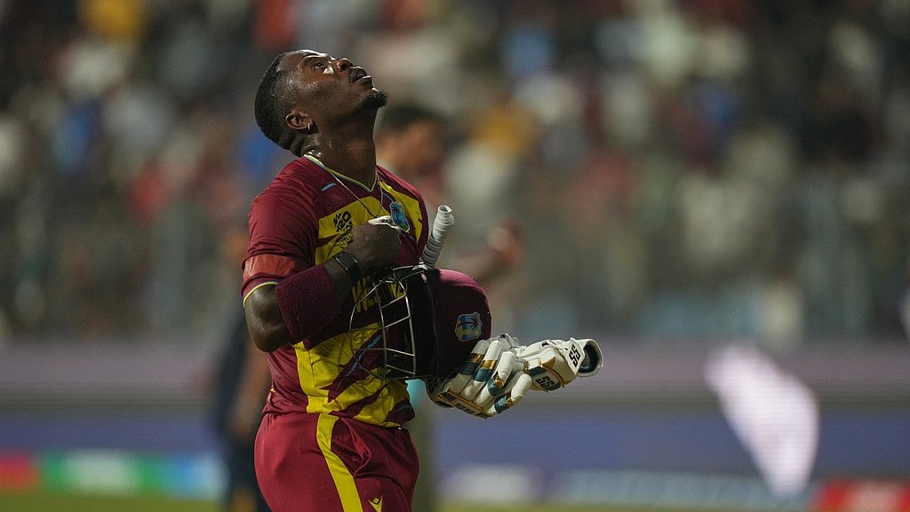 AP Photo/Rafiq Maqbool : West Indies' Sherfane Rutherford walks back at the end of the first half of the T20 World Cup cricket match between England and West Indies in Mumbai, India, Wednesday, Feb. 11, 2026. 