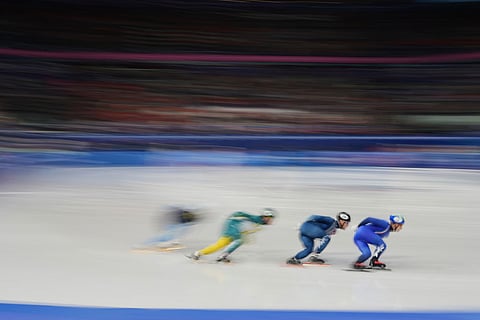 Pietro Sighel of Italy, right, leads his heat while competing in the men's 1000 meter short track speed skating at the 2026 Winter Olympics, in Milan, Italy.