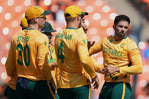 South Africa's Keshav Maharaj, right, and others celebrates the dismissal of Afghanistan's Darwish Rasooli during the T20 World Cup cricket match between Afghanistan and South Africa in Ahmedabad.