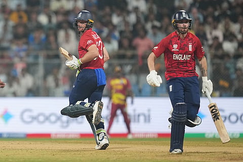 England's Jos Buttler, left, Phil Salt run between the wickets during the T20 World Cup cricket match between England and West Indies in Mumbai, India.