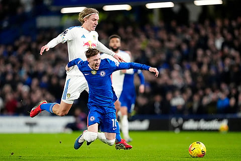Leeds United's Sebastiaan Bornauw, left, fouls Chelsea's Cole Palmer during their English Premier League soccer match in London.