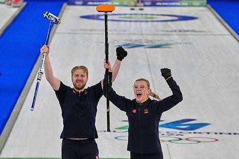 Sweden's Rasmus Wranaa and Isabella Wranaa celebrate after winning the gold medal mixed doubles curling match against USA, at the 2026 Winter Olympics, in Cortina D'Ampezzo, Italy.