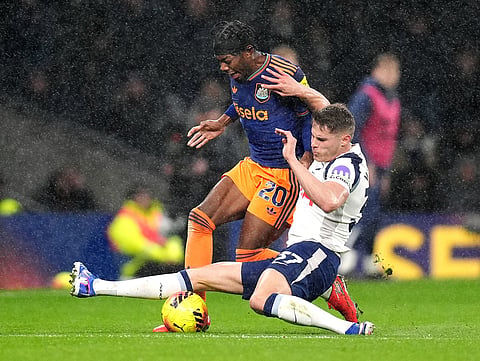 Newcastle United's Anthony Elanga (20) and Tottenham's Micky van de Ven battle for the ball during a Premier League soccer match London. 