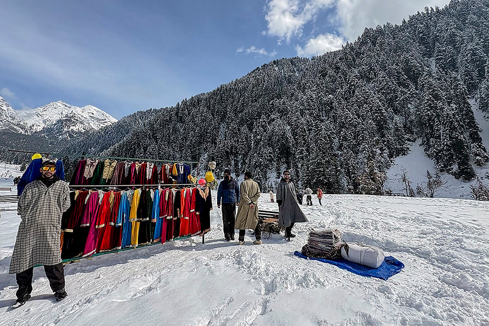 | Photo: PTI : Vendors put up a clothing stall during the 'Snow Festival' at Aru Valley, in Anantnag, Jammu and Kashmir.