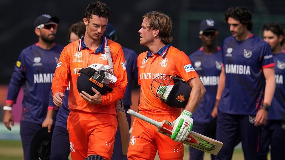 | Photo: AP/Manish Swarup : Netherlands' captain Scott Edwards, left and Netherlands' Bas de Leede walks out of the field after their win over Namibia during the T20 World Cup cricket match between Namibia and Netherlands in New Delhi.