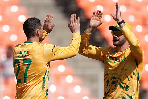 South Africa's captain Aiden Markram, right and George Lindeduring celebrates the dismissal of Afghanistan's Mohammad Nabi the T20 World Cup cricket match between Afghanistan and South Africa in Ahmedabad.