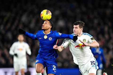 Chelsea's Joao Pedro, left, and Leeds United's Jaka Bijol battle for the ball during their English Premier League soccer match in London.