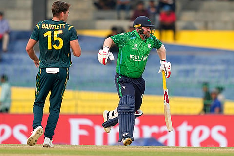 Ireland's captain Paul Stirling, right, limps as he runs between the wickets during the T20 World Cup cricket match between Australia and Ireland in Colombo, Sri Lanka.