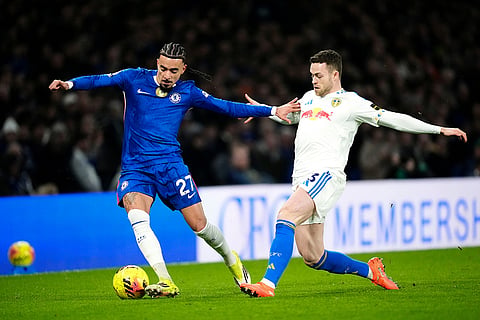 Chelsea's Malo Gusto, left, and Leeds United's Gabriel Gudmundsson battle for the ball during their English Premier League soccer match in London.