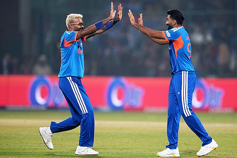 India's Hardik Pandya and Jasprit Bumrah celebrate the wicket of Namibia's Ruben Trumpelmann during the T20 World Cup cricket match between India and Namibia in New Delhi.