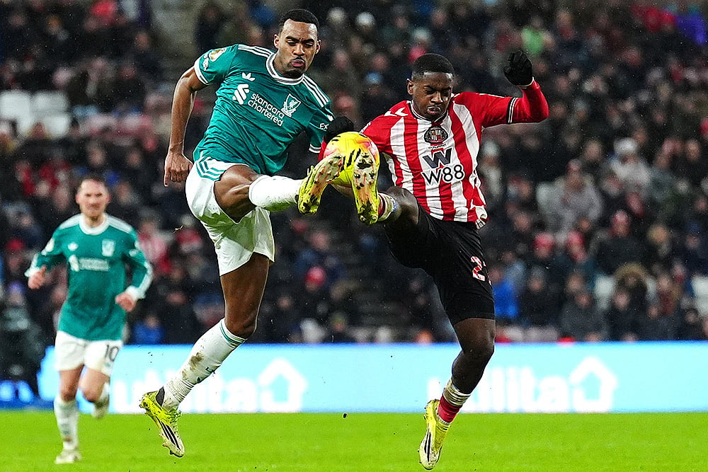 | Photo: Owen Humphreys/PA via AP : Liverpool's Ryan Gravenberch, left, and Sunderland's Noah Sadiki battle for the ball during the English Premier League soccer match, in Sunderland, England.
